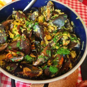 mussels in coconut curry in a large pot