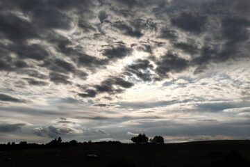 typical sky over cabin in the woods with clouds